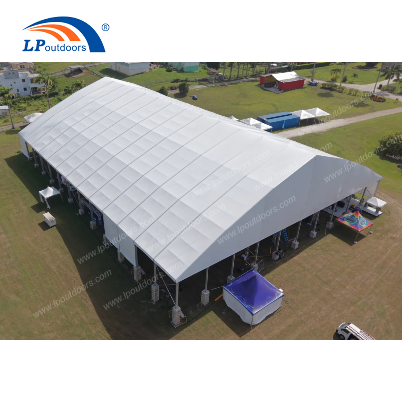 Exterior view of 50m large event marquee structure set up on lawn